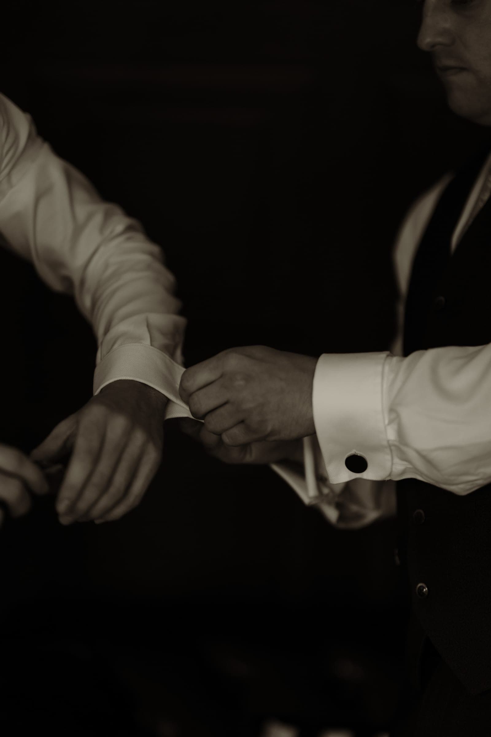 A quiet moment between the couple, hands held